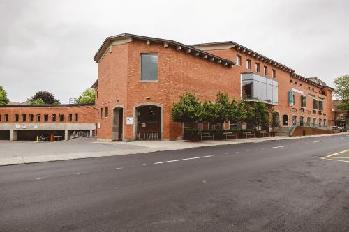 Side view of a brick building and entrance to the Central Branch library. 
