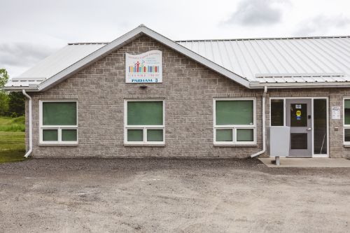 Short stone building with Library sign above two windows