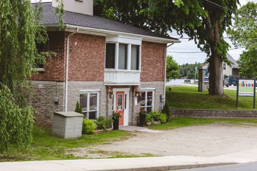 Brick and stone building with lake in the background.