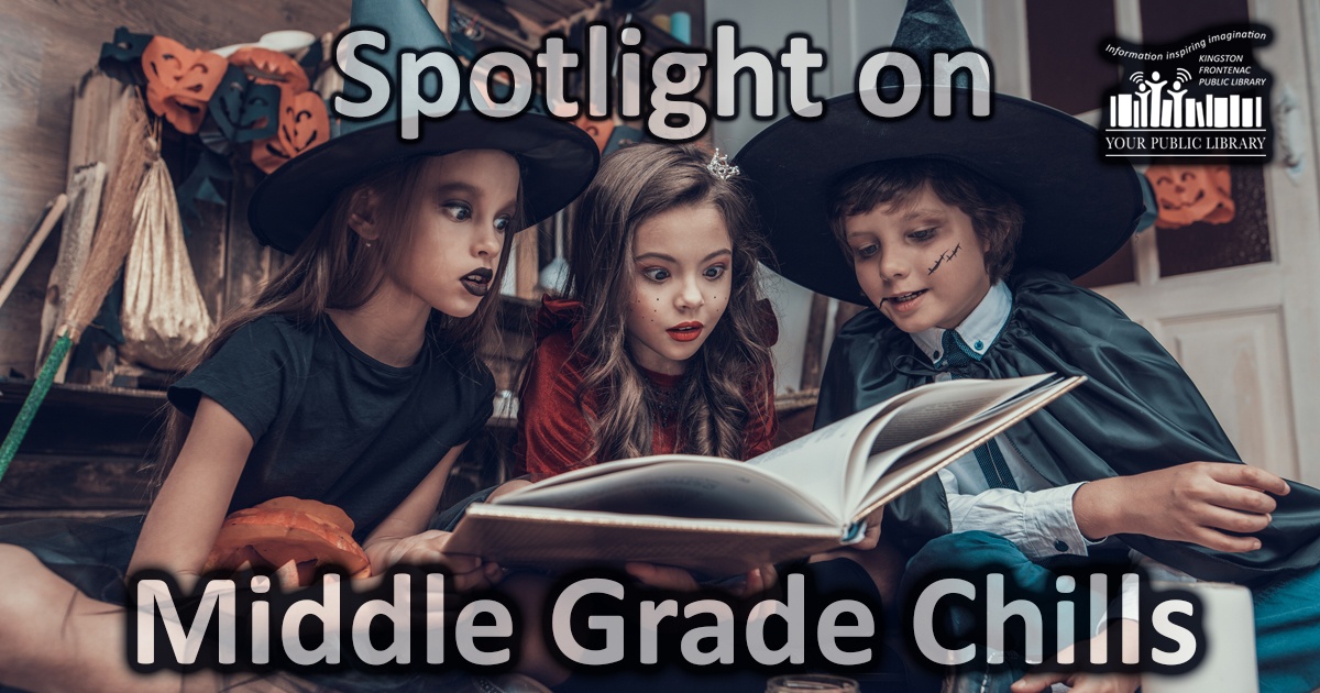 A group of kids in Halloween costumers look at a book.